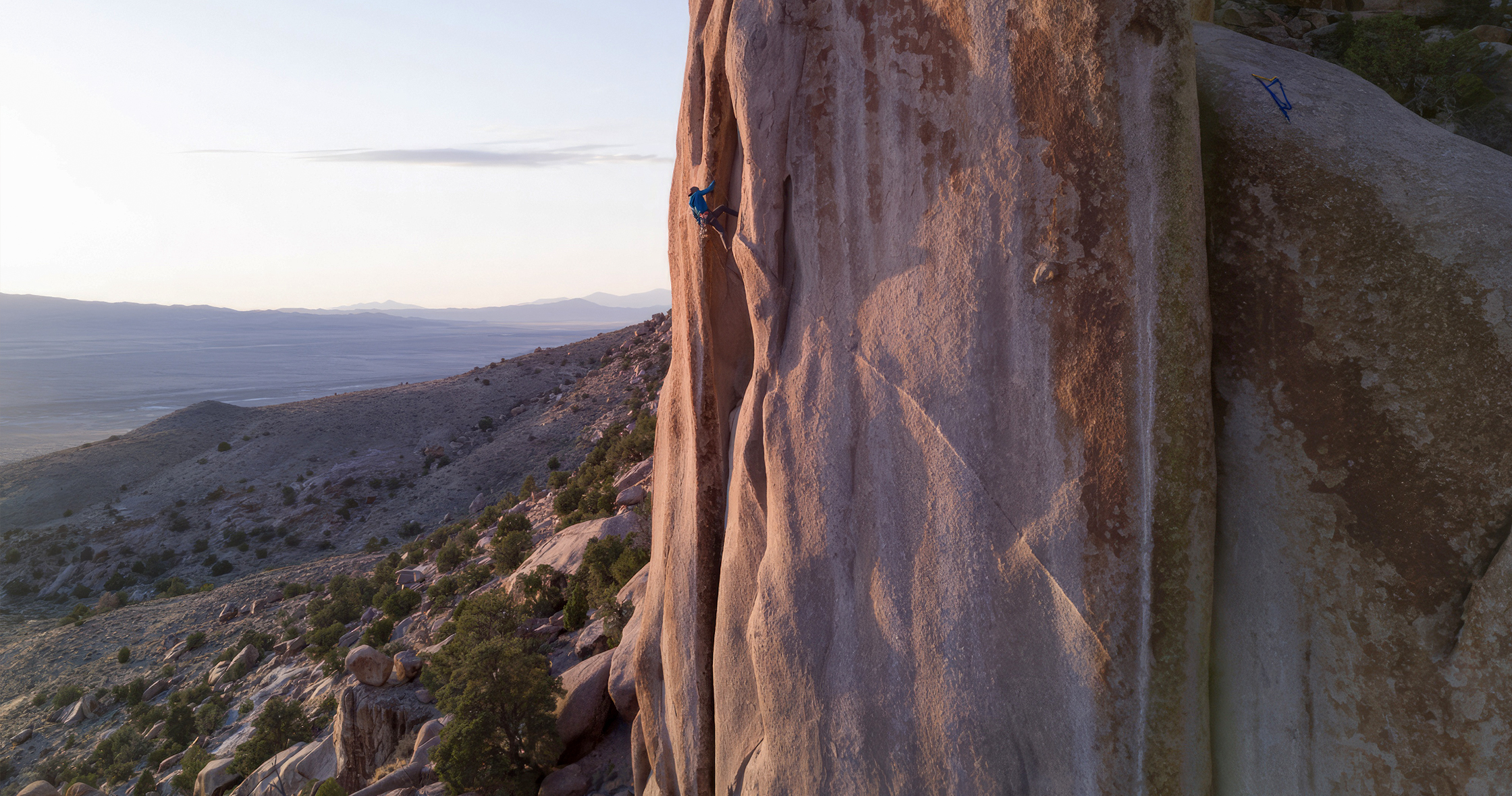 man free climbing in Utah at sunset